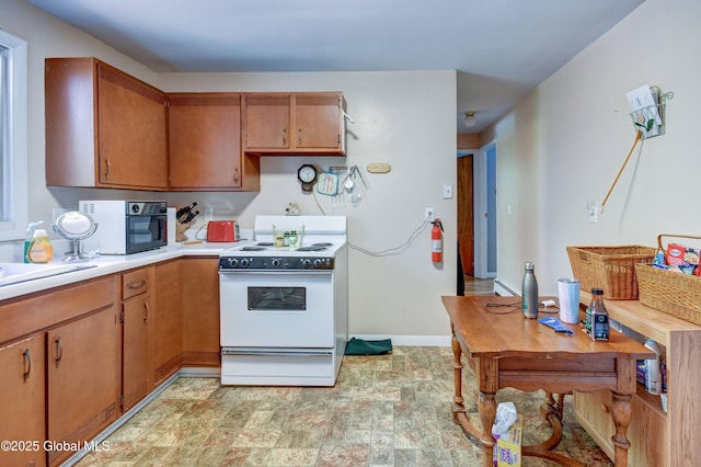292 N Main St, Northville, NY 12134 - kitchen with white range with electric cooktop, light countertops, baseboard heating, brown cabinets, and baseboards