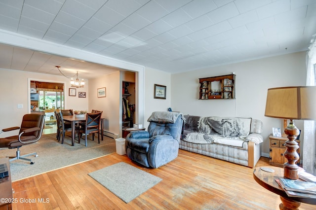 292 N Main St, Northville, NY 12134 - living room with a chandelier, wood-type flooring, ornamental molding, and baseboard heating