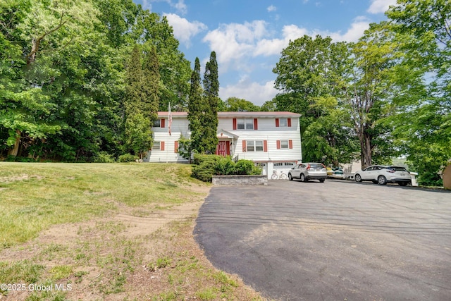 292 N Main St, Northville, NY 12134 - townhome / multi-family property with asphalt driveway, a garage, and a front lawn