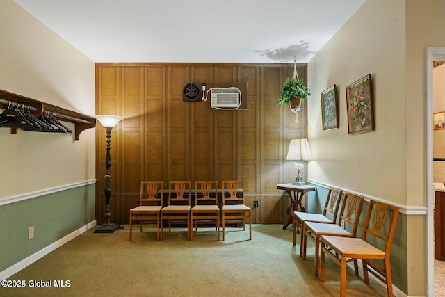 living area featuring carpet, an AC wall unit, and wood walls