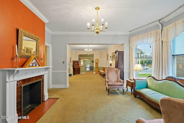 living area with carpet flooring, crown molding, a fireplace, and a notable chandelier