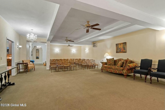 living room featuring carpet and ceiling fan with notable chandelier