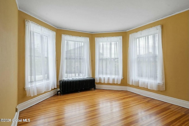 unfurnished sunroom featuring radiator heating unit