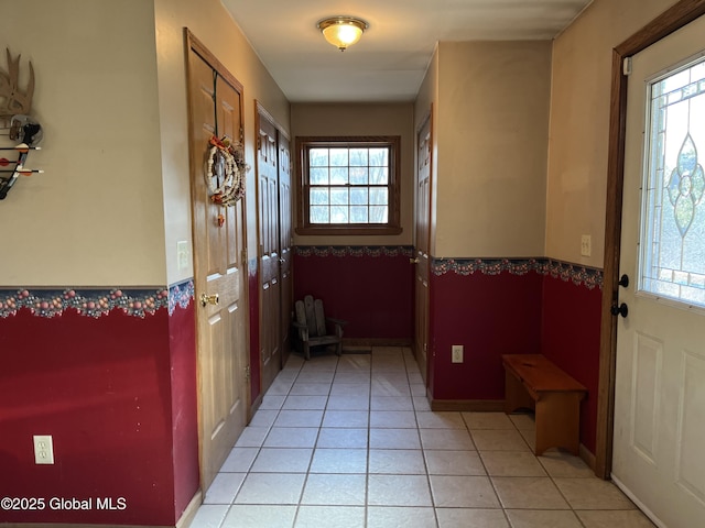 doorway featuring plenty of natural light and light tile patterned flooring