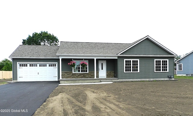 71 Bluebird Rd, Moreau, NY 12803 - view of front of house featuring an attached garage, a porch, driveway, and stone siding