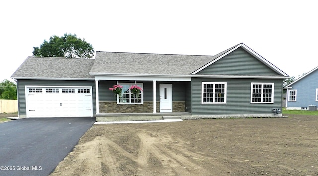 71 Bluebird Rd, Moreau, NY 12803 - view of front of house featuring a garage, a porch, asphalt driveway, stone siding, and a shingled roof