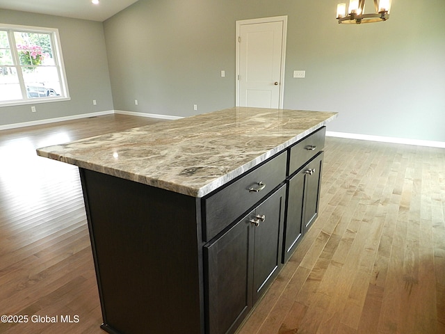 71 Bluebird Rd, Moreau, NY 12803 - kitchen featuring light wood-type flooring, a chandelier, a kitchen island, light stone countertops, and recessed lighting