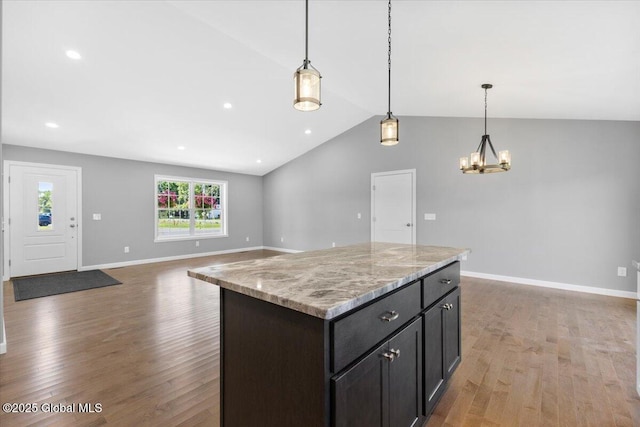 71 Bluebird Rd, Moreau, NY 12803 - kitchen with lofted ceiling, light wood-style flooring, a chandelier, a kitchen island, and pendant lighting