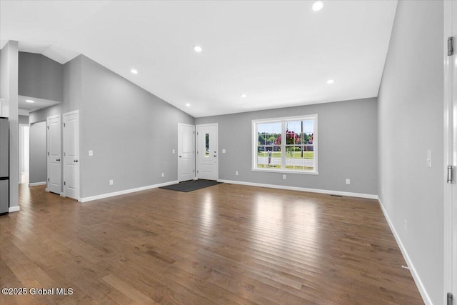 71 Bluebird Rd, Moreau, NY 12803 - unfurnished living room with lofted ceiling, wood finished floors, and recessed lighting