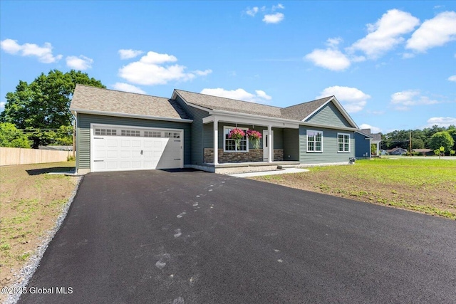 71 Bluebird Rd, Moreau, NY 12803 - ranch-style house featuring a garage, driveway, and covered porch