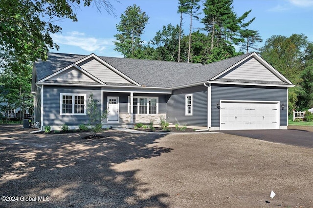 view of front of property featuring a garage and central air condition unit