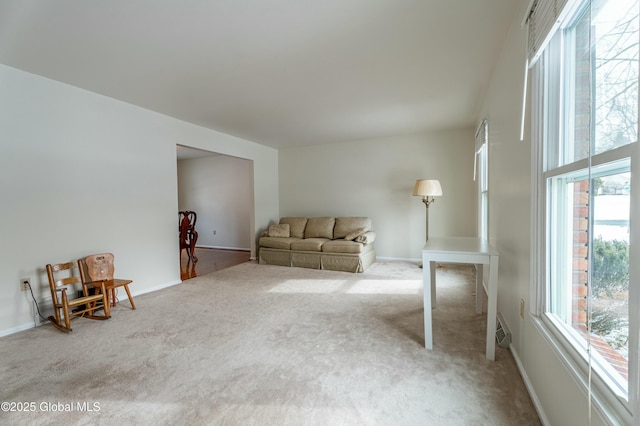 unfurnished room featuring light colored carpet and a wealth of natural light