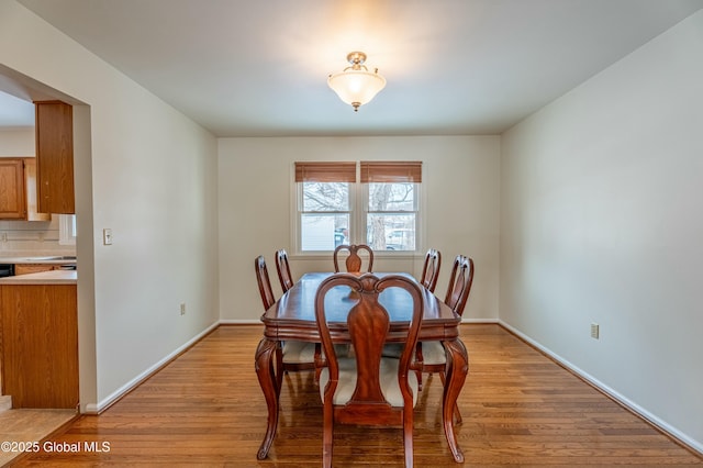 dining space with light hardwood / wood-style floors