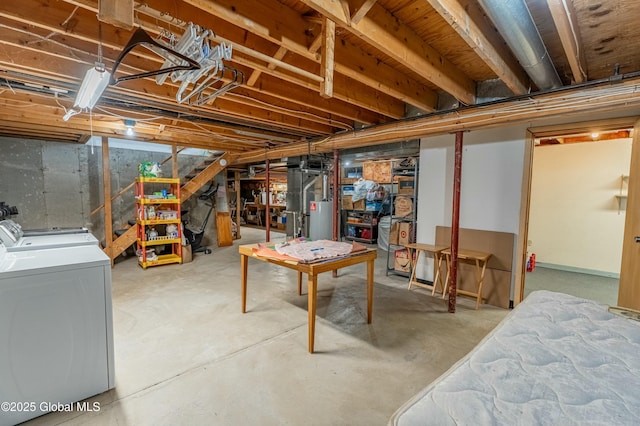 basement featuring washing machine and dryer and water heater