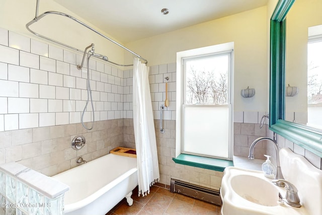 bathroom featuring tile patterned floors, a wealth of natural light, shower / bath combo, and a baseboard heating unit