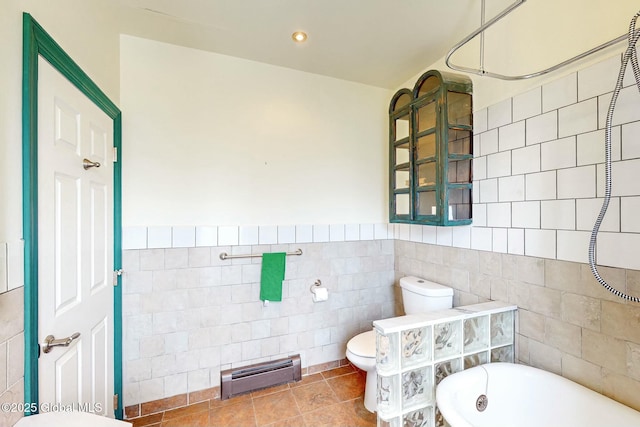 bathroom with tile patterned floors, toilet, separate shower and tub, tile walls, and baseboard heating