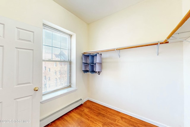 walk in closet with hardwood / wood-style flooring and a baseboard radiator