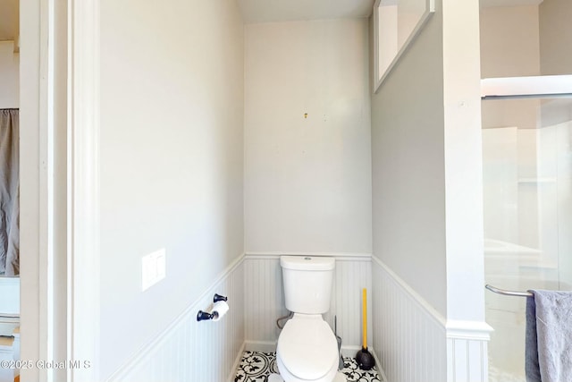 bathroom featuring a baseboard heating unit and toilet