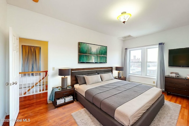 bedroom with hardwood / wood-style floors