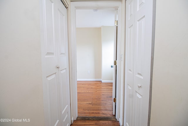 corridor with dark wood-type flooring