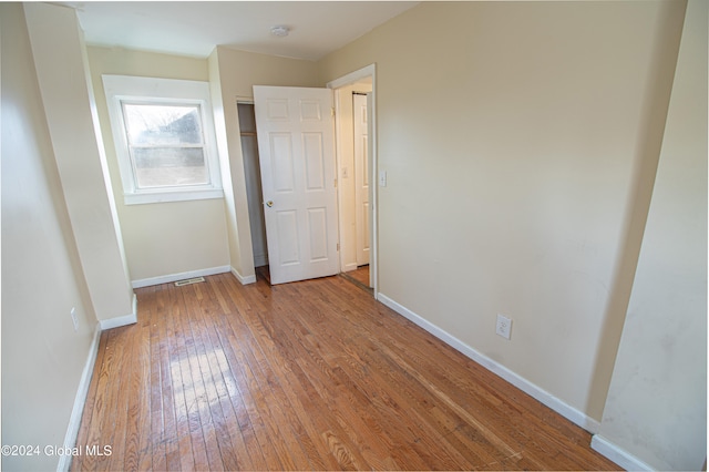 unfurnished bedroom featuring hardwood / wood-style flooring