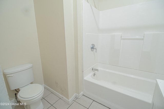 bathroom with tile patterned flooring, toilet, and shower / washtub combination