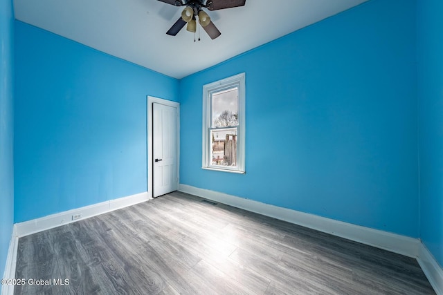 empty room featuring hardwood / wood-style flooring and ceiling fan