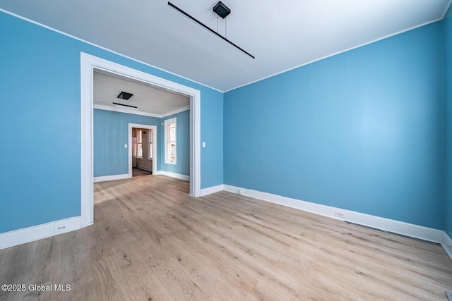 spare room with light hardwood / wood-style flooring and ornamental molding