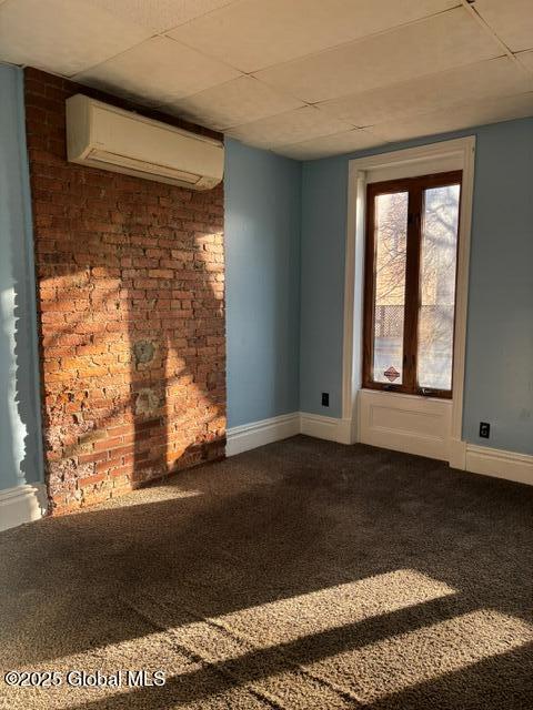 unfurnished living room featuring carpet and an AC wall unit