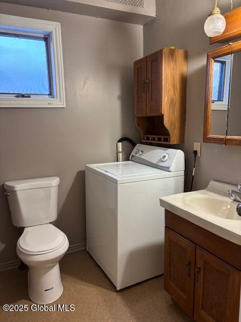 interior space with washer / dryer, vanity, and toilet