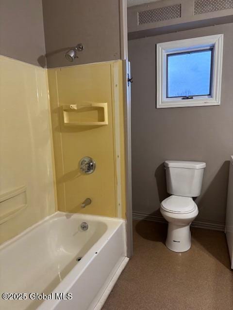 bathroom with bathing tub / shower combination and toilet