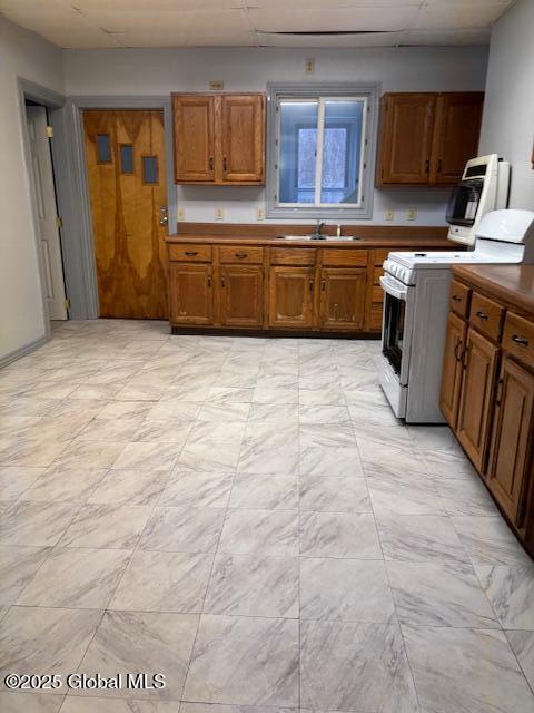 kitchen featuring white range with electric cooktop and sink