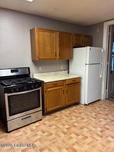 kitchen featuring white refrigerator and gas range