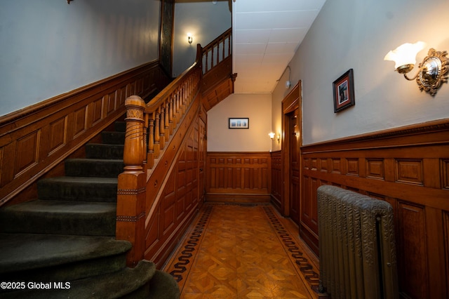 stairs featuring parquet floors