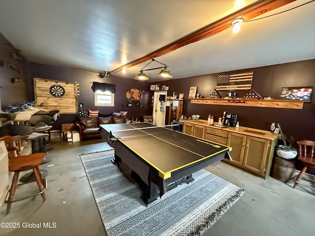 game room with beam ceiling and concrete flooring