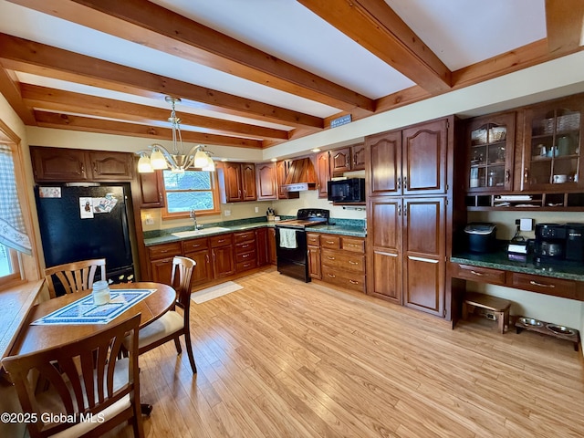 kitchen featuring black appliances, hanging light fixtures, beamed ceiling, a notable chandelier, and light hardwood / wood-style floors