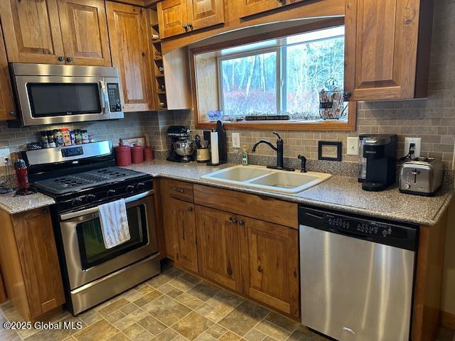 kitchen with tasteful backsplash, sink, and stainless steel appliances