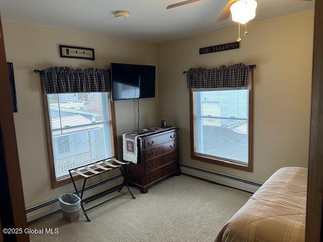 bedroom featuring ceiling fan, carpet floors, and a baseboard radiator