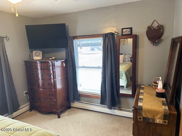 carpeted bedroom with baseboard heating