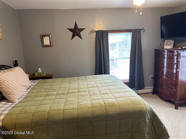 carpeted bedroom with baseboard heating