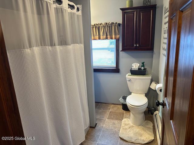 bathroom with toilet and baseboard heating