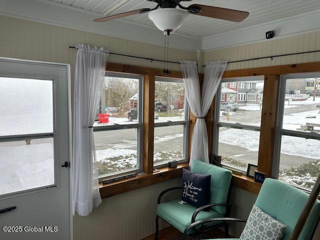 sunroom / solarium featuring ceiling fan