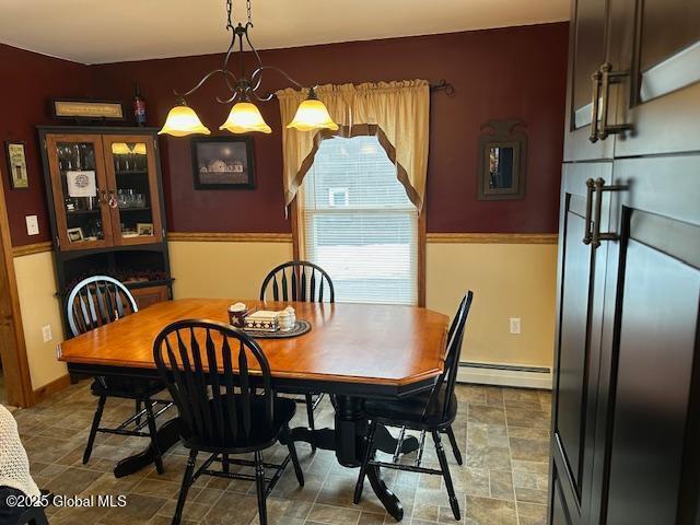 dining space with an inviting chandelier and a baseboard heating unit