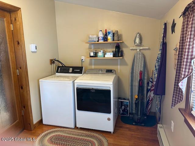 laundry area featuring separate washer and dryer, wood-type flooring, and a baseboard heating unit