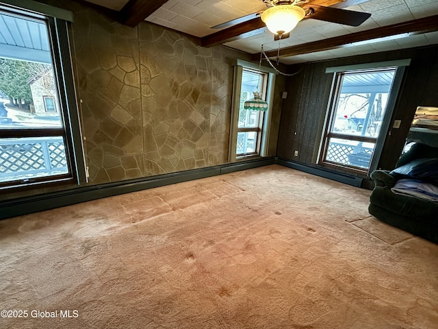 interior space with beamed ceiling, ceiling fan, and light carpet