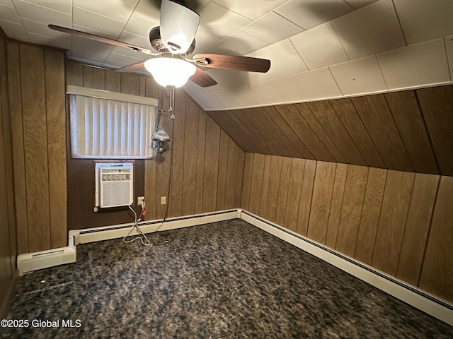 additional living space with ceiling fan, wooden walls, vaulted ceiling, and an AC wall unit