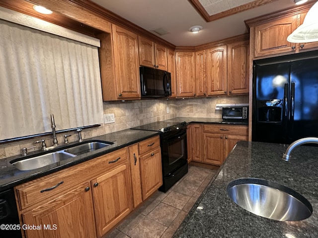 kitchen featuring tasteful backsplash, sink, black appliances, and dark stone countertops