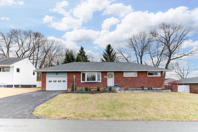 single story home featuring a garage and a front lawn