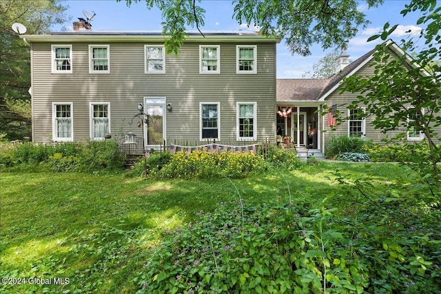 colonial inspired home with a front yard