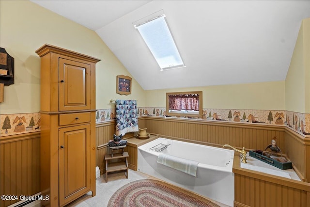 bathroom with lofted ceiling and a tub